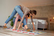 Couple having fun playing twister at home