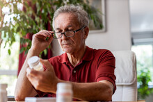 Senior Man Taking Prescription Medicine At Home
