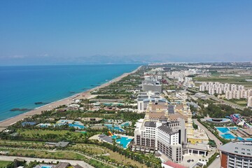 Wall Mural - Sandy beaches of the Mediterranean. Kundu holiday complex with five star hotels. Beach, sea, water sports, parasailing, entertainment and shopping center. Aerial view with drone. Kundu, Lara -TURKEY