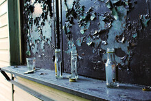 Glass Bottles On The Old Metal Background 