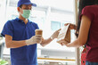 © KomootP - Asian courier or food delivery man service in protective mask and medical gloves delivers takeaway food to customer at home under quarantine coronavirus outbreak covid-19 pandemic by online order