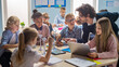 © Gorodenkoff - Elementary School Classroom: Enthusiastic Teacher Holding Tablet Computer Explains to a Brilliant Young Children How Wind Turbines Work. Kids Learning about Eco-Friendly Forms of Renewable Energy