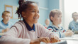 © Gorodenkoff - In Elementary School Class: Portrait of a Brilliant Black Girl with Braces Smiles, Writes in Exercise Notebook. Junior Classroom with Diverse Group of Children Learning New Stuff