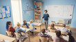 © Gorodenkoff - Enthusiastic Teacher Explaining Lesson to a Classroom Full of Diverse Bright Children, In Elementary School Group of Smart Multiethnic Kids Learning Science and Creative Thinking. High Angle Shot