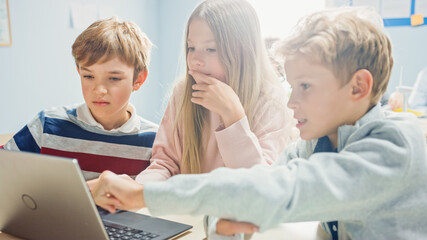 Elementary School Classroom: Diverse Group of Brilliant Children Using Laptop Computer for Software Programming, Talking and Working as a Team. Kids Learning Software Design and Creative Thinking