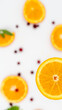 slice of orange with cranberries and mint on the background