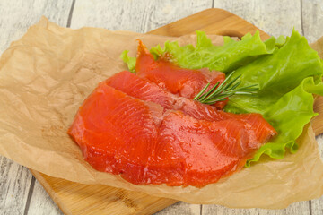 Sliced salmon fillet served rosemary