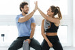 © blackday - High five between man and woman in the gym after fitness workout