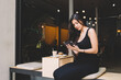 © BullRun - Charming female using digital tablet computer during lunch break in modern coffee shop outdoors, lovely woman reading fashion news on her touch pad while relaxing in restaurant during breakfast