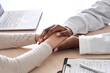 © insta_photos - African female doctor holding hand supporting caucasian woman patient. Kind ethnic professional physician give empathy concept encourage reassure infertile patient at medical visit, close up view.
