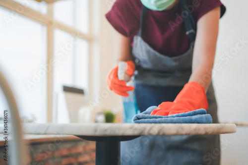 Cuadros en Lienzo cafe owner cleaning table before open in covid 19 situation