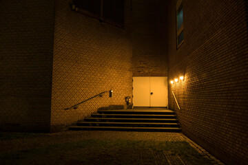 Aarhus, Denmark,  A back alley and stairs in the downtown illuminated by a single lamp source.