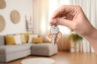 © New Africa - Woman with key in new modern apartment, closeup