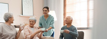 Young Woman Taking Care Of Elderly People In Living Room. Banner Design