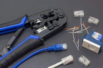 Lan cable crimpers, with Lan cable placed on the side and female socket head socket in a black background