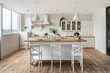 © brizmaker - White kitchen in apartment with modern interior