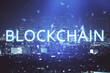 © peshkova - Multi exposure of cryptocurrency theme hologram drawing and city veiw background. Concept of blockchain and bitcoin.