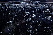 Air bubbles in the water, on a black background. the water begins to boil
