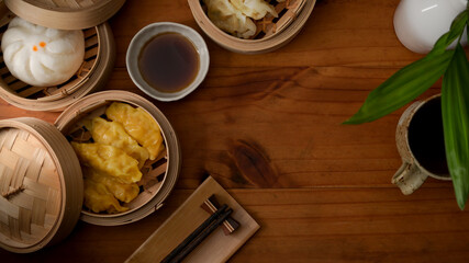 Wall Mural - Top view of steamed dumplings serving on bamboo seamer on wooden table