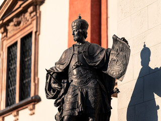 statue in front of basilica of the birth of the virgin mary in mariazell