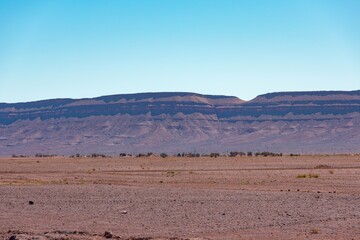 Sticker - View of desert mountains with an arid landscape against a blue sky