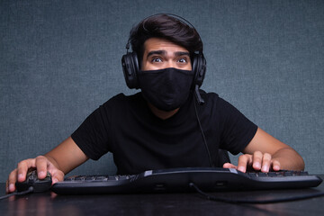 Young guy gamer playing an online video game