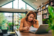 © bnenin - Tired woman doing paperwork at home, portrait.