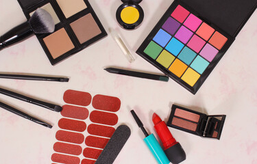 various cosmetics and cosmetics applicators on paper background