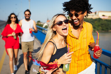 Wall Mural - Group of happy friends people having fun together outdoors