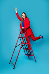 Sticker - Full length vertical photo of professional fancy lady successful worker come up career ladder wear luxury red suit blouse shirt blazer pants high-heels isolated blue color background