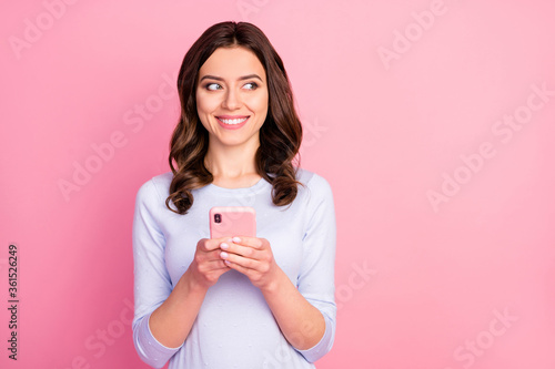 Photo of beautiful attractive lady hold telephone hands quarantine writing creative new post corona virus infection look side wear casual white shirt isolated pastel pink color background