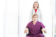 © Masato - Patient in a wheelchair and Female beautiful wearing a doctor uniform standing on the side.