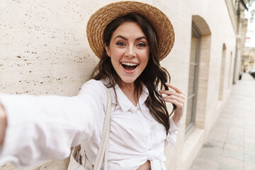 Poster - Portrait of beautiful cheerful woman smiling and taking selfie photo