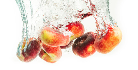 Wall Mural - Bunch of doughnut peaches isolated on white, splashing into water.