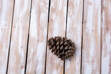 High Angle View Of A Pine Cone On A Wooden Table With Space For Your Text
