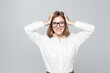 © dianagrytsku - Portrait of unhappy young businesswoman holding hands in head isolated on white background