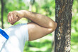 © Vahe - a man shows muscle on a green background