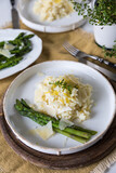 Fototapeta Tulipany - Creamy lemon risotto with parmesan and asparagus on white plate.