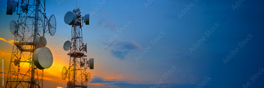 Telecommunication towers with wireless antennas on sunset sky - obrazy, fototapety, plakaty 