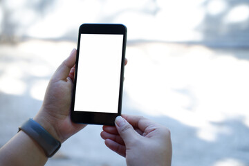 women using smartphone at abstract blurred street. Blank screen for graphics display montage.