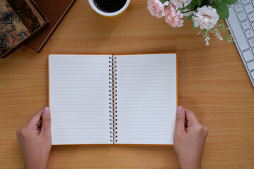 overhead view of hands holding a blank book ready with copy space.