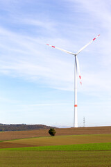 Wall Mural - A windmill on a field with blue sky