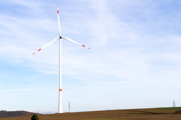 Wall Mural - A windmill on a field with blue sky