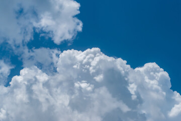 Wall Mural - Clouds in blue sky background with copy space
