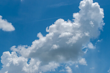 Wall Mural - Clouds in blue sky background with copy space