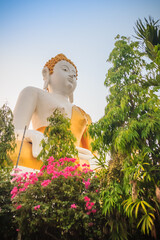 Wall Mural - Beautiful big buddha image at Wat Phra That Doi Kham. Chiang Mai, Thailand. Wat Phra That Doi Kham (Wat Doi Kham or the Golden temple) is located at the top of a hill to the south west of the city.