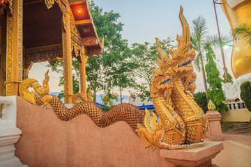 Wall Mural - Beautiful exterior decoration at Wat Phra That Doi Kham. Chiang Mai, Thailand. Wat Phra That Doi Kham (Wat Doi Kham or the Golden temple) is located at the top of a hill to the south west of the city.