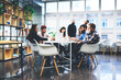 © BullRun - Group of casually dressed businesspeople discussing ideas in the office. Creative professionals gathered at the meeting table for discuss the important issues of the new successful startup project