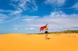 © sitriel - Happy woman on Red sand dunes in Vietnam