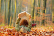 © Jacek - Child reading a book, colorful autumn in the park. Hobbies and rest.